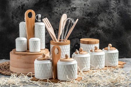 Modern ceramic kitchenware set with wooden accents on a rustic countertop. copy space.