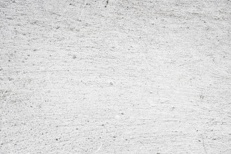 White rough concrete wall with subtle horizontal lines and light texture for background.の写真素材