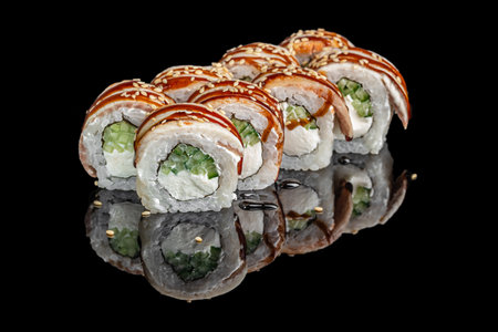 Japanese sushi rolls with cream cheese cucumber and eel on black background.の写真素材