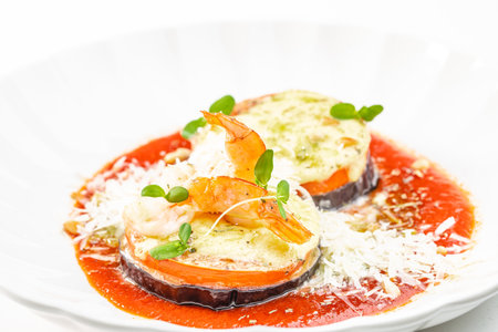 Baked eggplant and shrimp with tomato sauce and cheese. copy space.