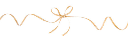 Golden decorative ribbon tied in a bow isolated on white background for festive gift wrapping and holiday design.の写真素材