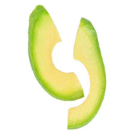 Two avocado slices isolated on white background, fresh green tropical fruit pieces, organic healthy food concept advertising or bannerの写真素材
