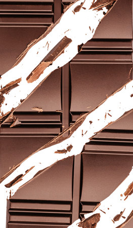 Broken dark chocolate bar with sharp cracks and scattered chocolate pieces isolated on white background, abstract food texture with copy space for design.の写真素材
