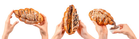 Woman holding croissants topped with chocolate drizzle and powdered sugar, sweet bakery concept isolated on light background.の写真素材