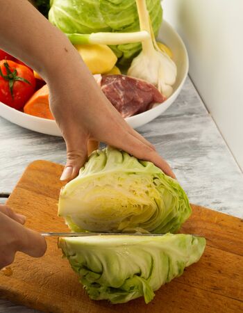 Make Ukrainian borscht with vegetables and meat. Shred the cabbage.の写真素材