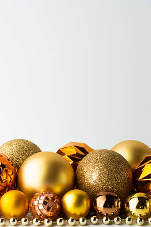 Festive background of golden textured Christmas balls. Postcard with space for writing text.の写真素材