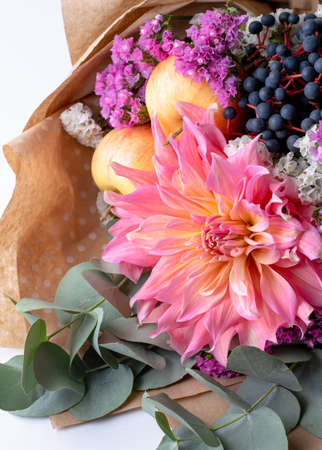 Delicate bouquet with a beautiful dahlia, eucalyptus, colored limonium, apples.の写真素材