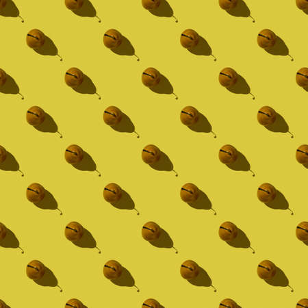 Seamless pattern on a yellow background from ripe pears, top view.Background with fresh pears.