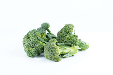 On a white plate slices of fresh broccoli. Healthy vegetarian food.