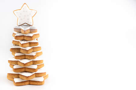 Christmas tree made of gingerbread cookies on a white background with space for writing text.の写真素材