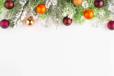 Fir branches with multi-colored Christmas balls, cones, decor on a white background with space for writing text. Top view.の写真素材