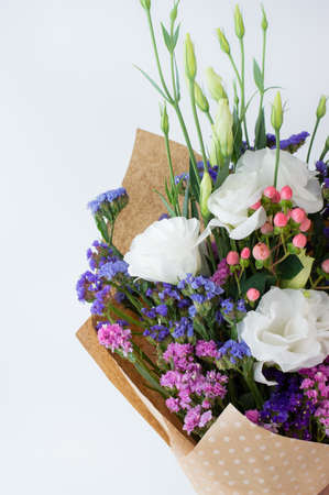 Multicolored floral bouquet on a white background with a place for writing text.の写真素材