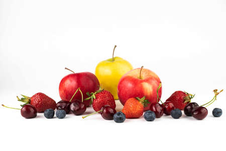 On a white background, strawberries, blueberries, cherries, apples. fruit background.