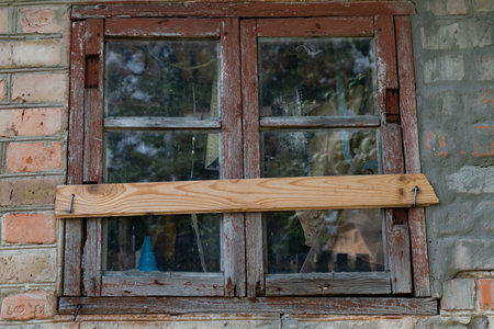 A window in an old house of poor people. The concept of material inequality.の写真素材
