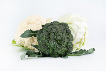 On a white background, broccoli, cauliflower and ordinary cabbage. Healthy food concept.の写真素材
