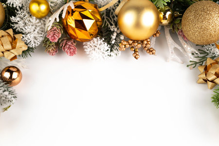 On a white background with space for writing the text, fir branches and decor in gold color. Christmas background.の写真素材