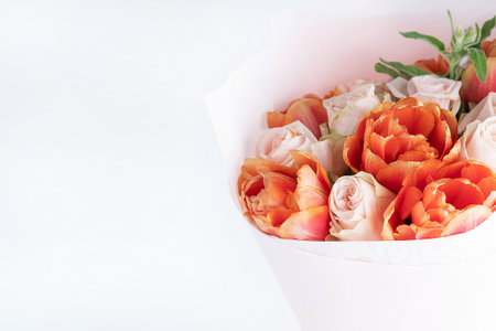 On a white background, a bouquet of delicate roses and tulips. Delicate romantic background.の写真素材