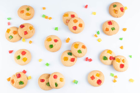 Round cookies with candied fruits are laid out on a white background.の写真素材