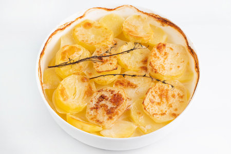 Baked potatoes with thyme sprigs. The concept of cooking homemade food.の写真素材