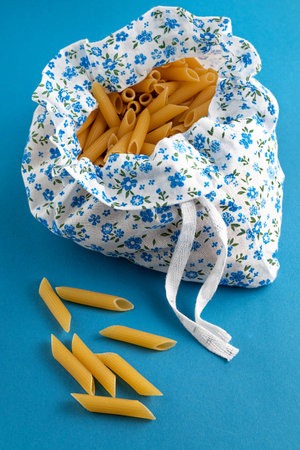 Pasta in a reusable eco cotton bag on the table.Sustainable lifestyle concept.Items without plastic. Reuse, reduction.の写真素材