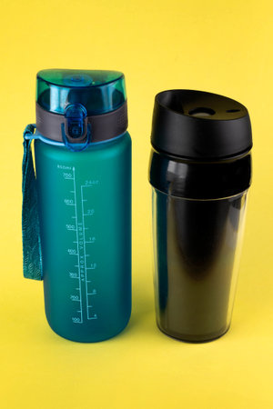 Reusable plastic drinkware on a yellow background.Sustainable lifestyle concept.の写真素材