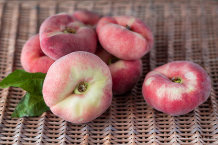 Peaches on a wicker natural background.Summer background.の写真素材