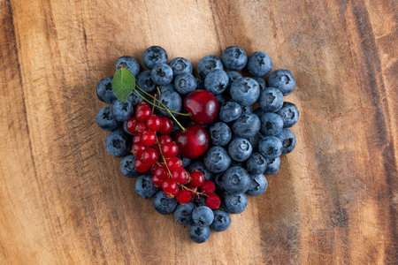Blueberry heart on a wooden background. summer background.の写真素材