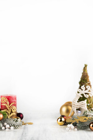 On a light background there is a small Christmas tree, a candle and New Year's decor. New Year background with space for writing text.の写真素材