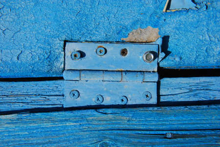 Door hinge on old wooden surface.の写真素材