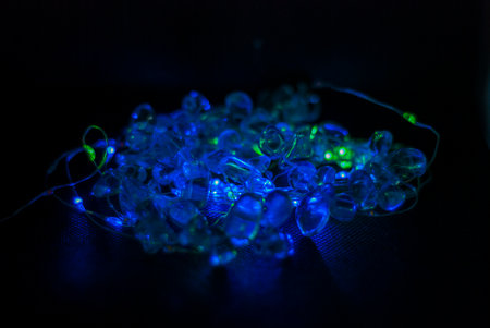 blue led garland on a dark background close-up macro photo