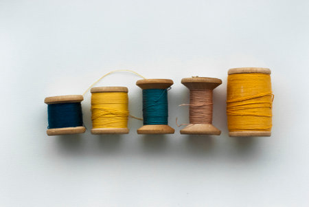 Colorful spools of thread on a white background. Copy space.