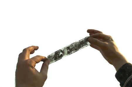 man hand with old film on the whiteの写真素材