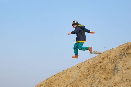 boy running in the spring skyの写真素材
