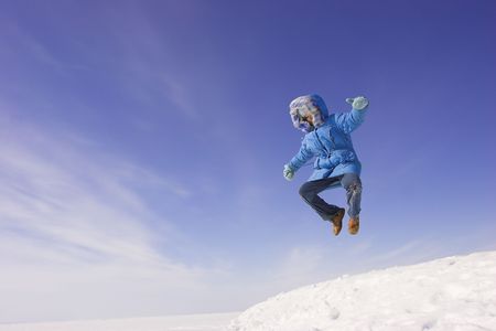 Happy winter day. Flying girl on the blue skyの写真素材