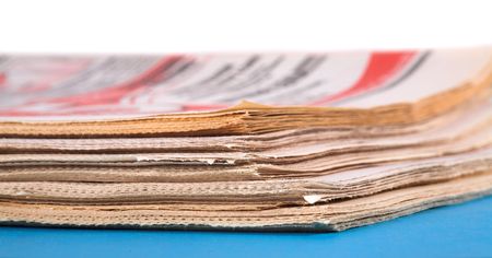 pile of old newspapers on the blue table 