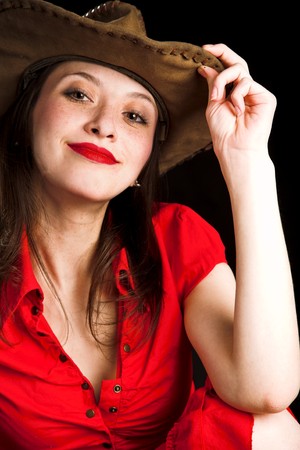 Girl sitting and covering herself with hatの写真素材