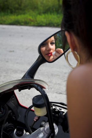 young beauty girl with motorbike on the roadの写真素材