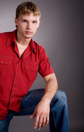 Young handsome man on grey isolated backgroundの写真素材