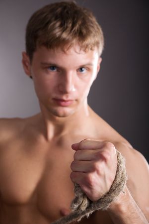 Man with belt on grey isolated backgroundの写真素材