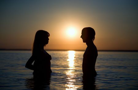 couple of happy lovers on the evening beachの写真素材
