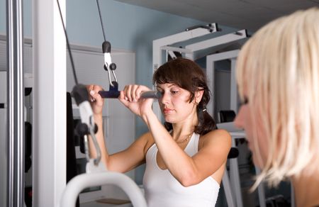 Fitness. Young caucasian women in the gym