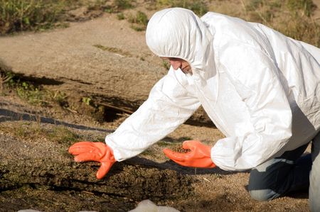 man in protective wear on the lake beachの写真素材