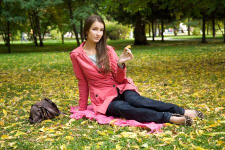 young beauty girl in the autumn parkの写真素材