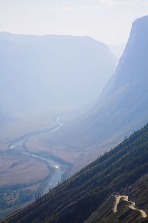 Road going through two ranges of mountainの写真素材