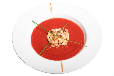tomato soup in white plate isolated on whiteの写真素材