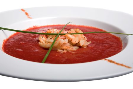tomato soup in white plate isolated on whiteの写真素材
