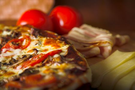 pizza with red tomato cheese and  porkの写真素材