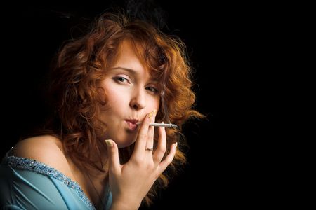 young beauty girl with cigarette on blackの写真素材