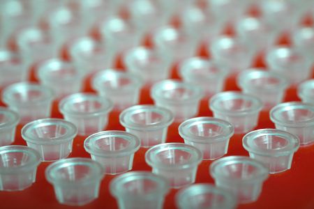 small plastic tubes in the red rackの写真素材