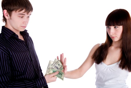 young woman rejecting man's offerの写真素材